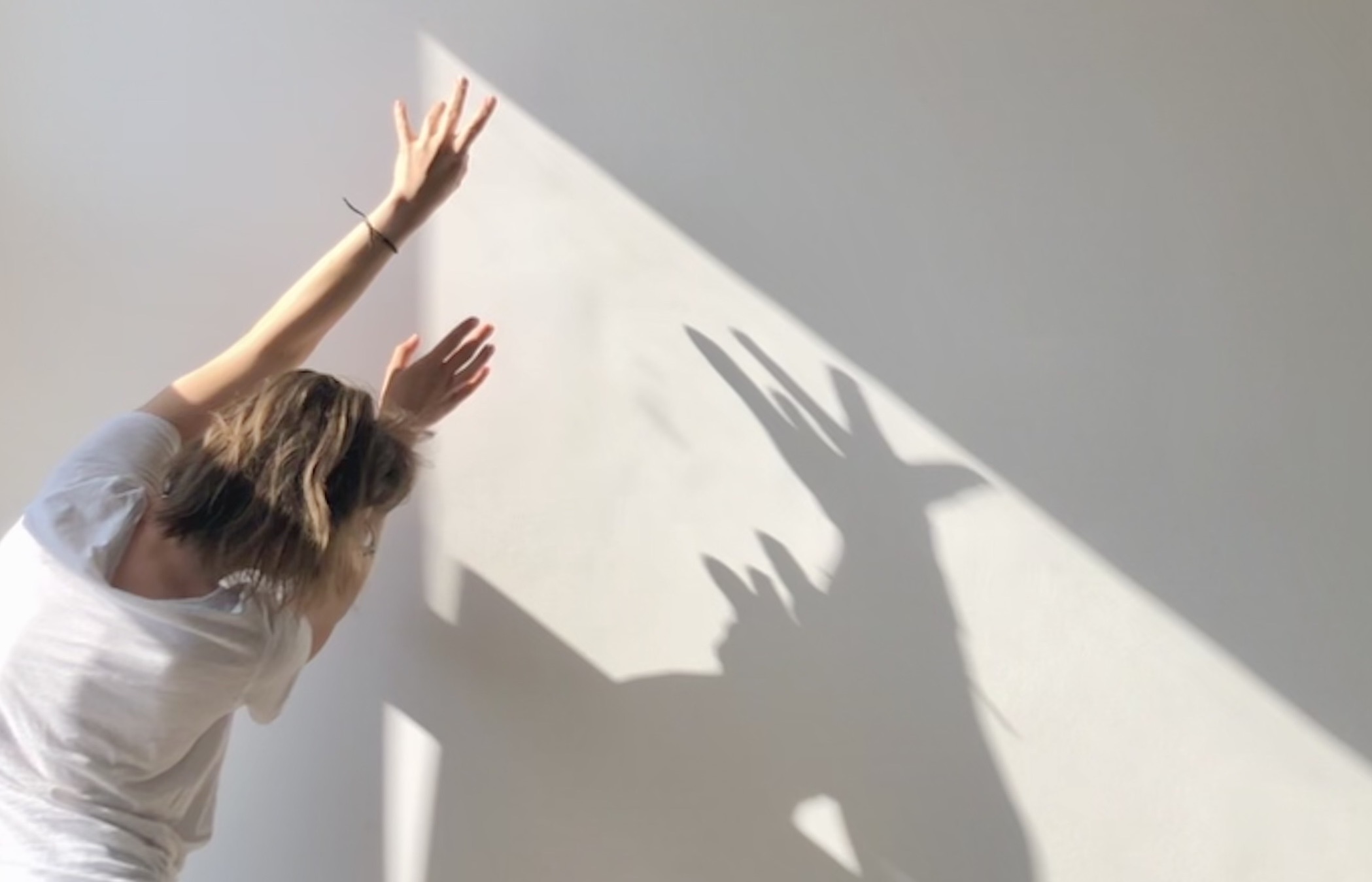 woman seen from behind raising her hands